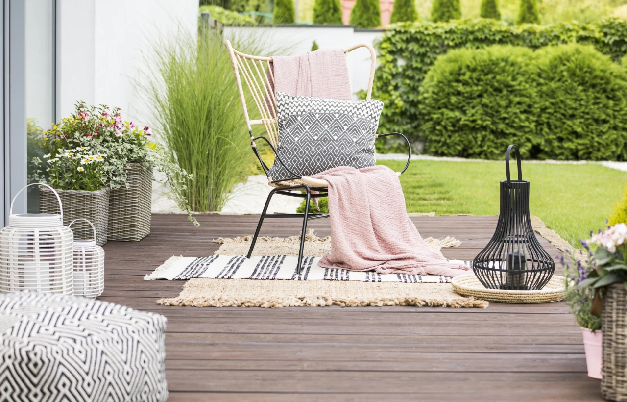 Outdoor patio with chair and pillows.