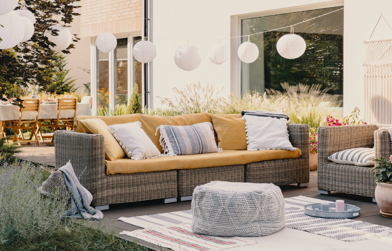 Outdoor patio with wicker furniture and lanterns.