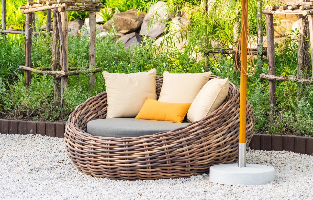 Wicker patio chair with cushions outdoors.