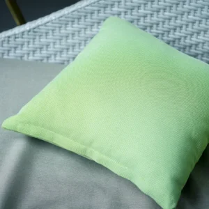 Green pillow on grey patio furniture.