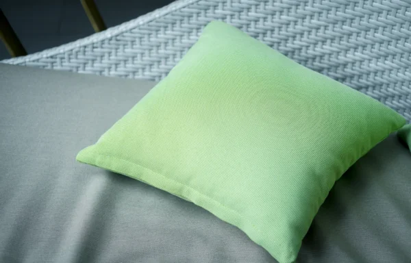 Green pillow on grey patio furniture.