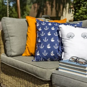 Couch with nautical themed pillows and books.