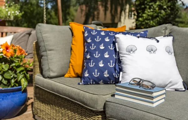 Couch with nautical themed pillows and books.