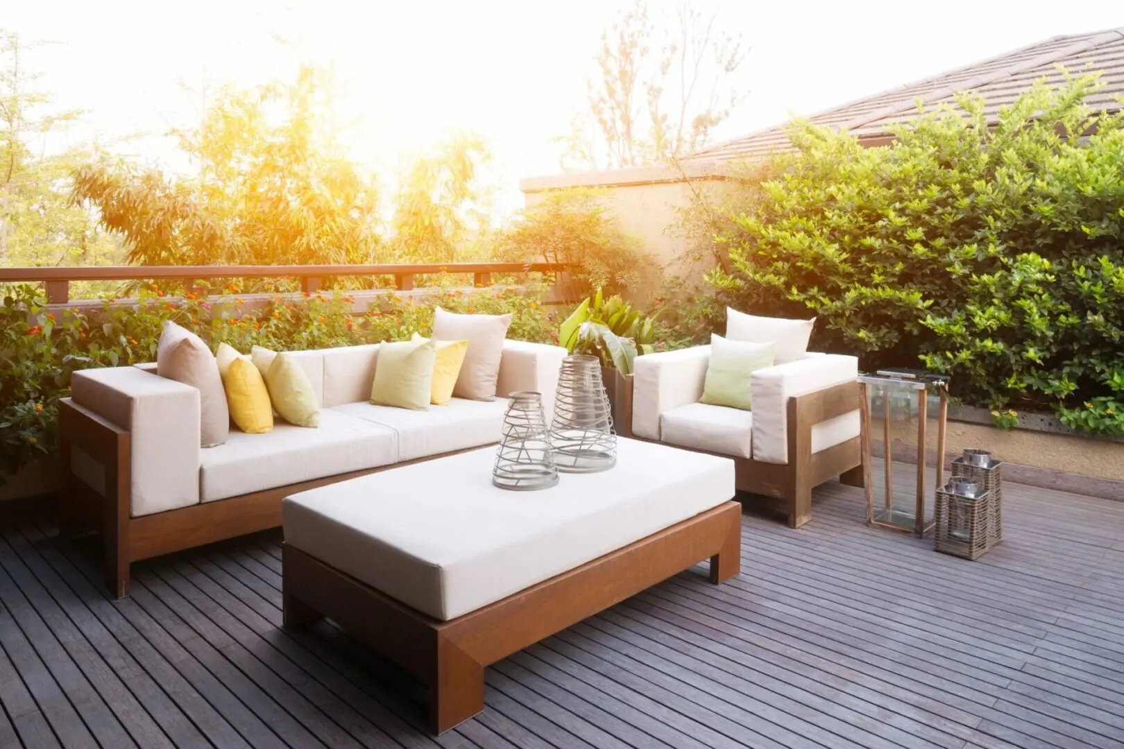 A patio with furniture and a table in the middle of it.