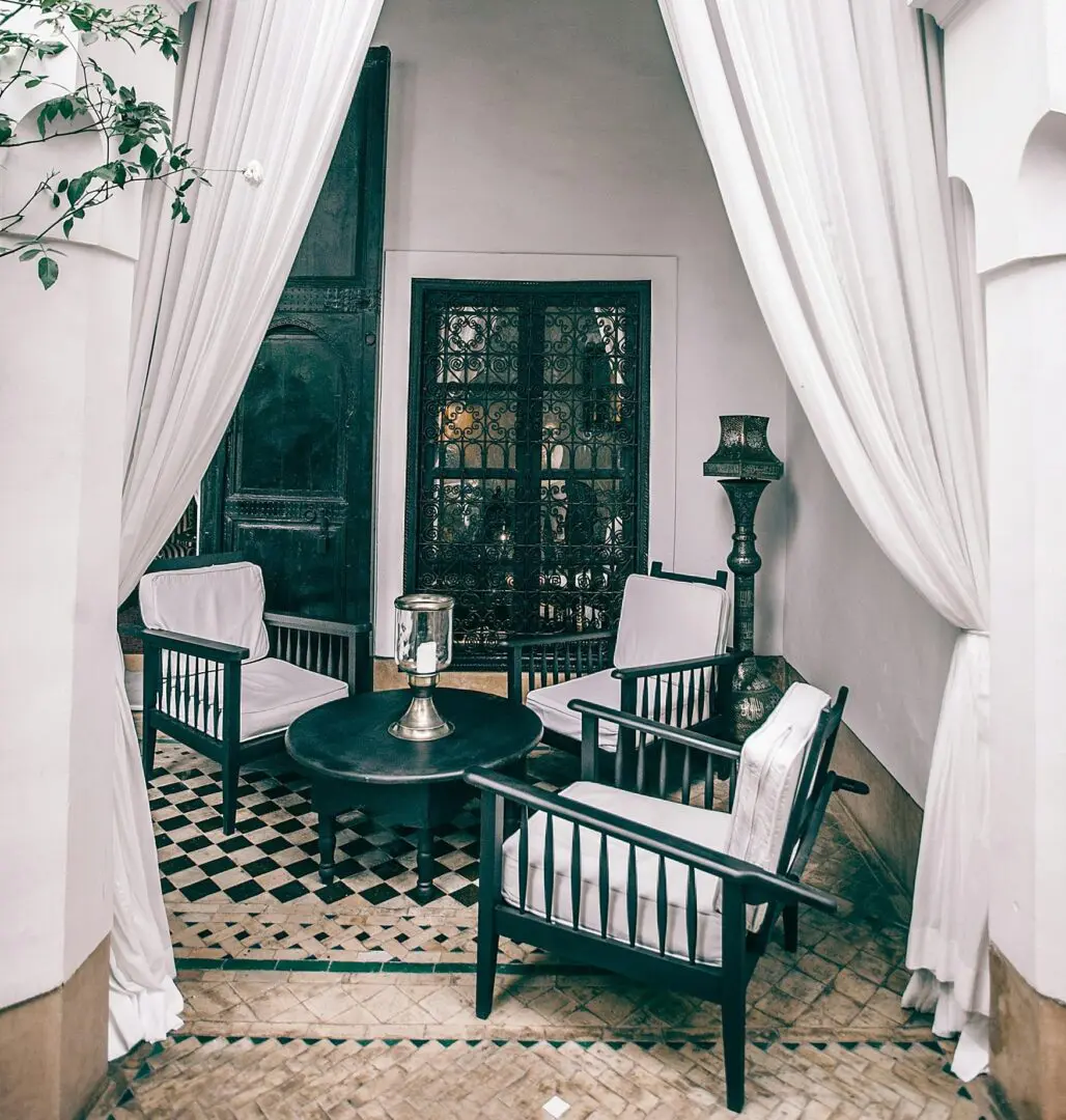 A room with white walls and black furniture.